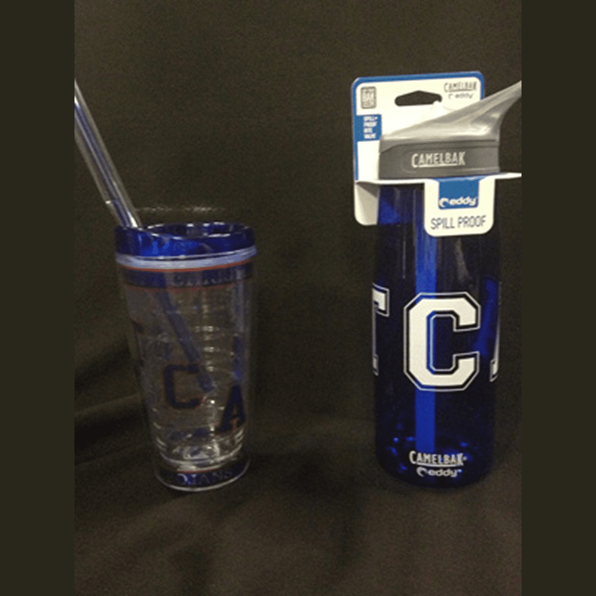 Spill-proof CamelBak bottle next to tumbler.